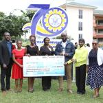 Mr. Emmanuel Okoh (2nd from left), Manager of Kumasi City Mall, presenting a cheque of GHS 10,000 on behalf of Broll Ghana Limited to support brilliant but needy students in the Department of Estate Management, KsTU. Also in the photo is Dr. Lewis Abedi Asante (4th from right), Head of Department, together with the two beneficiaries (in red and yellow) and staff of the department after the presentation.
