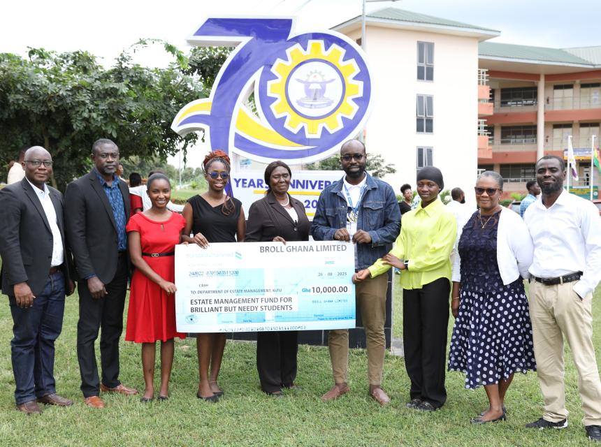 Mr. Emmanuel Okoh (2nd from left), Manager of Kumasi City Mall, presenting a cheque of GHS 10,000 on behalf of Broll Ghana Limited to support brilliant but needy students in the Department of Estate Management, KsTU. Also in the photo is Dr. Lewis Abedi Asante (4th from right), Head of Department, together with the two beneficiaries (in red and yellow) and staff of the department after the presentation.